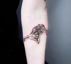 Get inked with a striking blackwork hand tattoo by Oek on your upper arm. Stand out with this unique illustrative design.