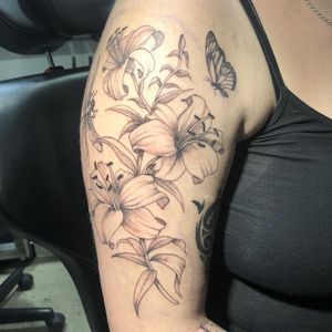 A stunning blackwork tattoo of a flower on the upper arm, expertly done by the talented artist Pablo.