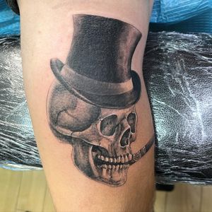 Unique blackwork and realistic design featuring a skull wearing a hat and smoking a cigar, by Pablo.