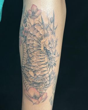 Get a stunning illustrative tattoo of a Japanese dragon and flower by the talented artist Pablo.