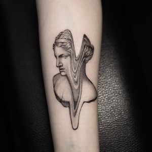 Get a stunning illustrative blackwork tattoo of a statue on your forearm by the talented artist Oek. Stand out with this unique and artistic design.
