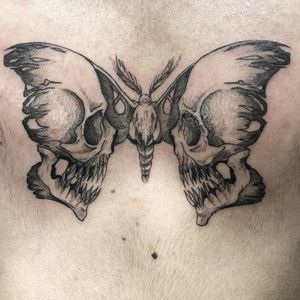 Get inked with this striking blackwork butterfly and skull design on your chest by Pablo. Express your edgy and beautiful side.