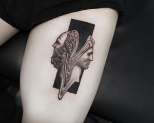 Illustrative blackwork tattoo of a man statue on upper leg by artist Oek. Bold and striking design.