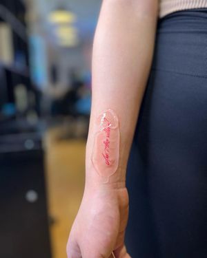 Delicate fine line forearm tattoo by Alina Ivenko featuring small lettering quote.