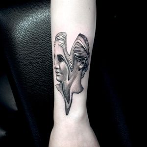Get inked with a stunning blackwork tattoo of a female statue on your forearm, done by the talented artist Oek.