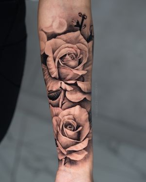 Realistic floral tattoo on the forearm 