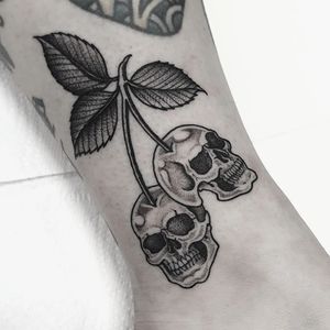 Unique blackwork design by Dani Mawby featuring a skull and cherry motif on the ankle.