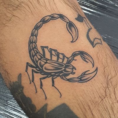 Get a bold and traditional scorpion tattoo on your lower leg with intricate blackwork details by the talented artist Dani Mawby.