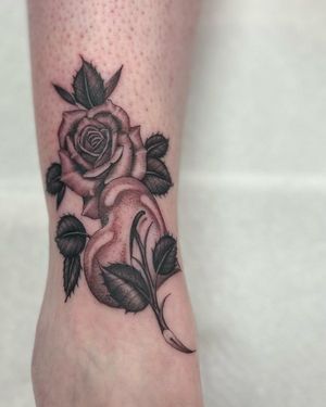 Get a stunning blackwork flower tattoo on your lower leg by artist Dani Mawby. Perfect for adding a touch of nature to your look.