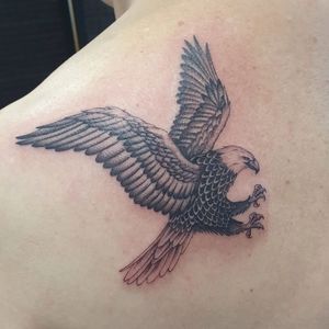 Get a striking blackwork eagle tattoo on your shoulder by the talented Dani Mawby for a bold and powerful look.