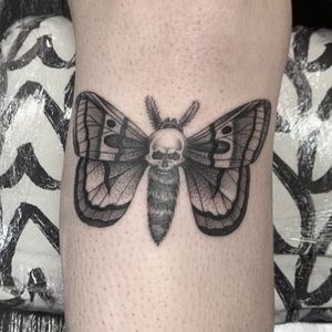 Unique blackwork design on shin by tattoo artist Dani Mawby. Features a blend of butterfly and skull motifs.