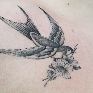 Elegant fine line tattoo of swallows in London, created with expert black & gray shading for a timeless look.
