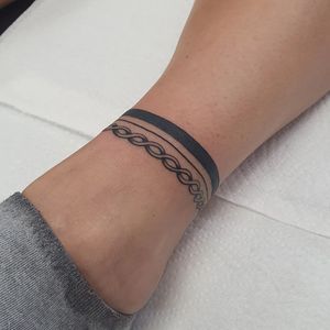 Get a stunning patterned ankle tattoo by Dani Mawby, combining blackwork and fine line illustration styles.