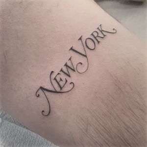 Celebrate your love for the city that never sleeps with this elegant fine line tattoo featuring a meaningful quote and your name by Dani Mawby. Perfect for your arm!