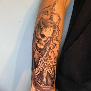 Illustrative blackwork tattoo featuring a skull, grim reaper, skeleton, and scythe by Carlos Hernandez. Perfect for those who embrace the darker side of life.