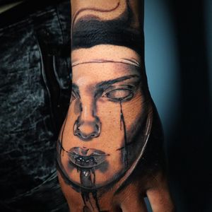 Capture the elegance of a woman with this black and gray illustrative hand tattoo by Carlos Hernandez.