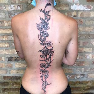 Stunning blackwork flower design by Carlos Hernandez that beautifully decorates your back with intricate details.