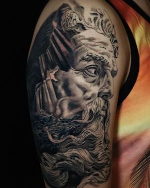 Get inked with this stunning black and gray illustrative tattoo of Poseidon on your upper arm by Carlos Hernandez.