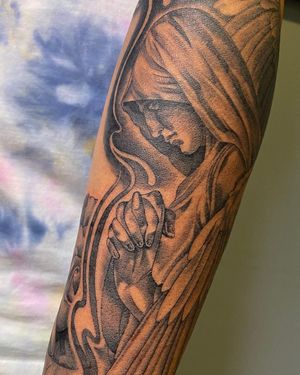 Illustrative black and gray tattoo of a woman resembling Mary, on the forearm by artist Carlos Hernandez.