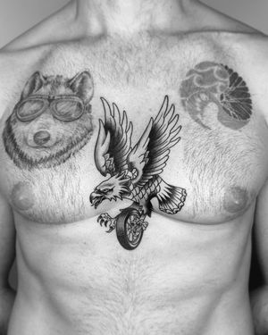 A striking blackwork eagle tattoo on the chest, beautifully illustrated in a traditional style by the talented artist Marcos.