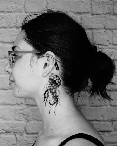 Capture the graceful movement of a jellyfish with this blackwork design by Marcos. Perfect for those looking for a unique and bold neck piece.