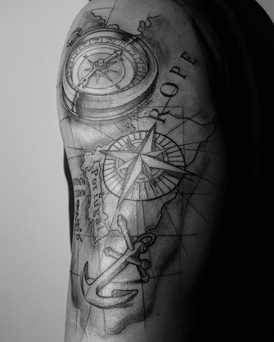 Explore the world with this fine line black and gray illustrative tattoo featuring a compass and map, personalized with your favorite country name. Perfect for upper arm placement.