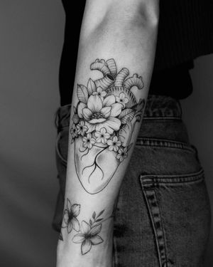 Unique forearm tattoo by Marcos featuring a beautiful blackwork design of a flower and heart. Perfect for those who appreciate detailed and artistic tattoos.