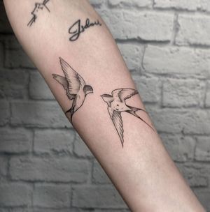 Stunning blackwork bird tattoo on forearm, expertly done by Marcos. The intricate design will surely captivate attention.