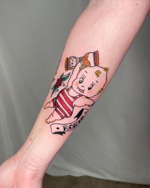 Unique blend of lettering, flower, skull, hourglass, kewpie, and name illustration on forearm. A masterpiece by Sasha.