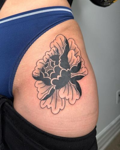 A beautiful blackwork peony flower tattoo on the hip, expertly done by Sasha. Enhance your feminine grace with this stunning design.