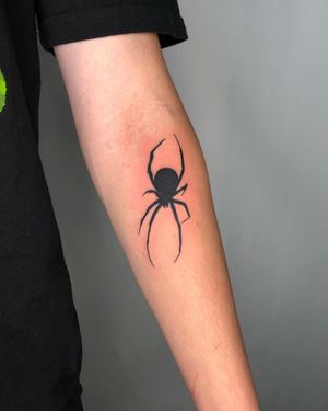 Capture attention with Sasha's intricate blackwork spider design on your forearm. Perfect for those who love bold tattoos.