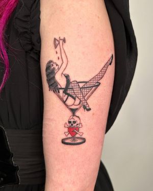 Unique upper arm tattoo by Sasha featuring a heart, skull, woman, glass, skirt, bones, and girl in a detailed style.