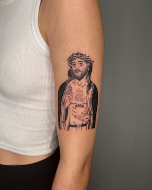 Traditional tattoo of Jesus with thorns and a cigarette on the upper arm, done by Sasha.