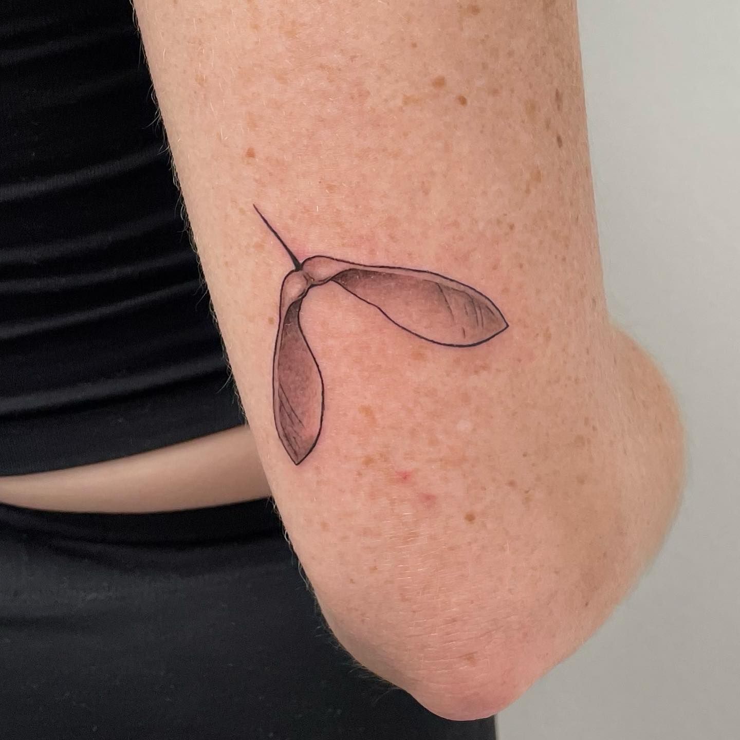Fine line woman sprouting tattoo located on the