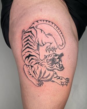 Sasha's stunning blackwork and illustrative design depicting a powerful tiger on the upper leg. Make a statement with this fierce tattoo!