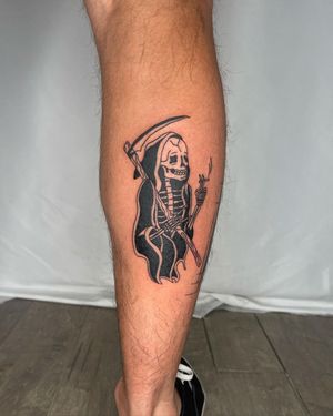 Dark and detailed lower leg tattoo featuring a skull, Grim Reaper, skeleton, scythe, and a cigarette. Created by Sasha in an illustrative style.