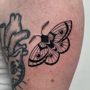 Unique blackwork design on upper arm by Nic V, combining the beauty of butterflies and moths.
