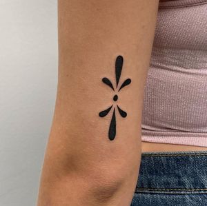 Get inked by Nic V with this elegant blackwork and illustrative design featuring a stylish floral pattern on your upper arm.