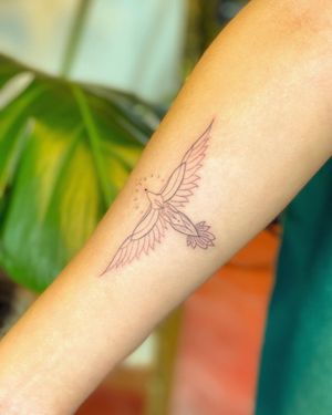 Stunning forearm tattoo by Fabian Lopez Barreda combining intricate fine line bird design with intricate patterns.