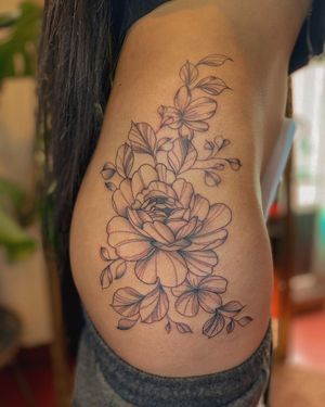 Elegant floral design on upper leg by tattoo artist Fabian Lopez Barreda. Perfect combination of blackwork and illustrative style.