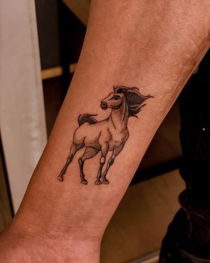 Capture the beauty of nature with this blackwork horse tattoo by Fabian Lopez Barreda, perfect for your forearm.