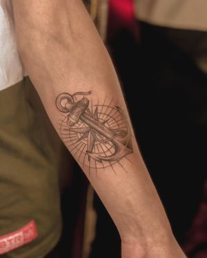 An intricate anchor and compass design in fine line illustrative style, perfect for the forearm. Express your love for travel and adventure with this stunning piece.