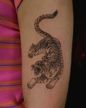 Capture the fierce beauty of a tiger with this illustrative fine line tattoo by Fabian Lopez Barreda. Perfect for a bold and striking look!