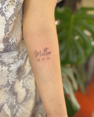 Get a beautifully detailed name tattooed on your forearm with fine line work and small lettering, designed by Fabian Lopez Barreda.