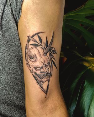 Illustrative tattoo by Fabian Lopez Barreda featuring a hannya mask, leaf, and earrings.