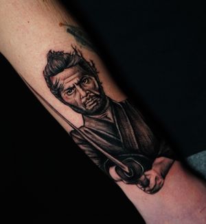 Impressive forearm tattoo by Miss Vampira features a chilling samurai with a sword in detailed blackwork style.