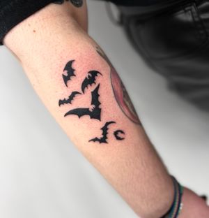 Get a striking blackwork bat tattoo by Miss Vampira on your forearm for a bold and unique look.