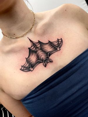 Elegant blackwork design of a bat by tattoo artist Miss Vampira, perfect for a bold chest piece.
