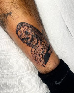Let Miss Vampira bring your nightmares to life with this blackwork zombie book tattoo on your lower leg. A truly chilling addition to your collection.