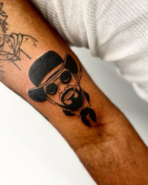 Exude charm and style with this blackwork illustrative tattoo of a man in a hat and glasses, with a cigarette in hand. By talented artist Miss Vampira.